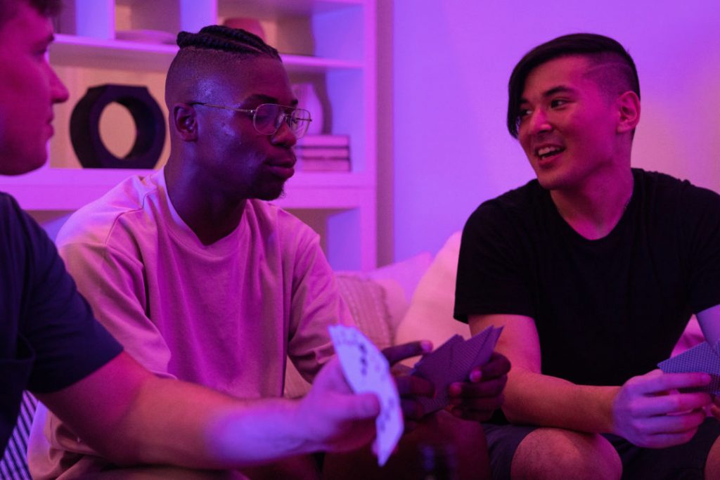 LGBT group of young men gamble while playing texas holdem