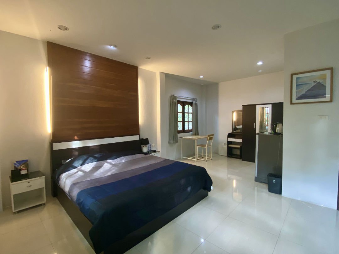 Bedroom with writing desk and hotel amenities