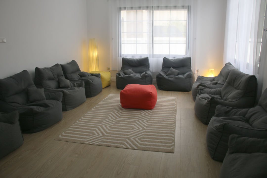 Cozy group counseling room with beanbags and rug