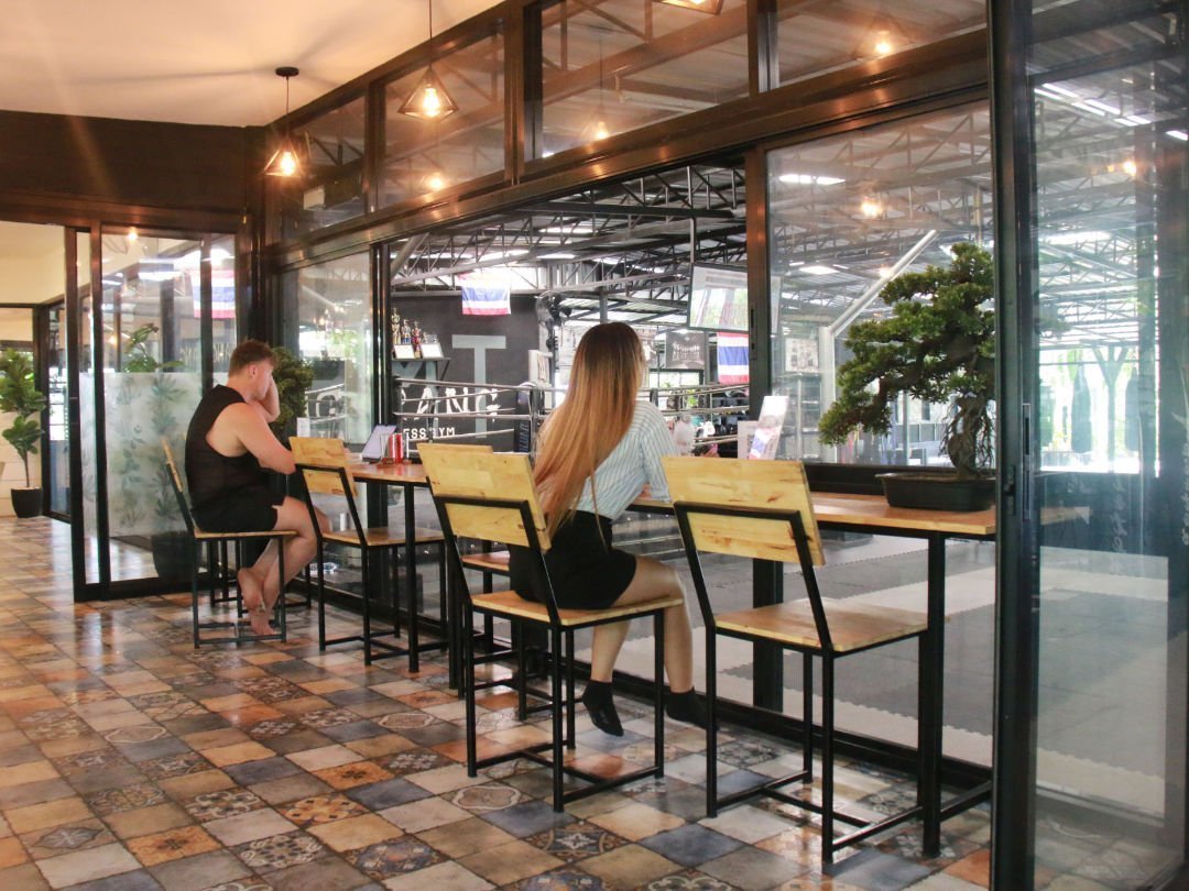 Former addicts sit at juice bar at Thai rehab facility