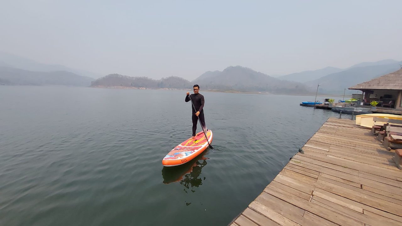 Drug rehab staff member enjoys paddle board on lake