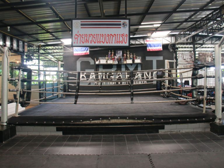 Thailand flags and trophies surround boxing ring