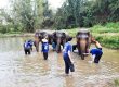 One Step residents throw water over elephants in jungle pond
