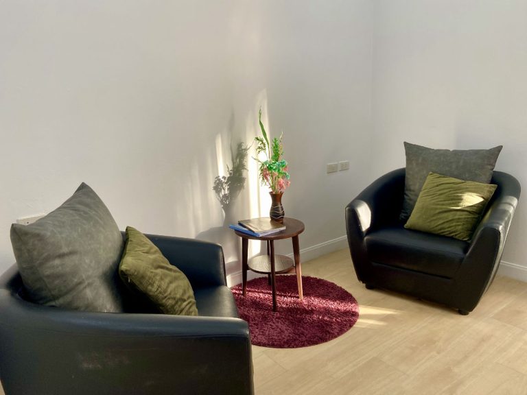 Minimal individual addiction and mental health counseling room with 2 chairs