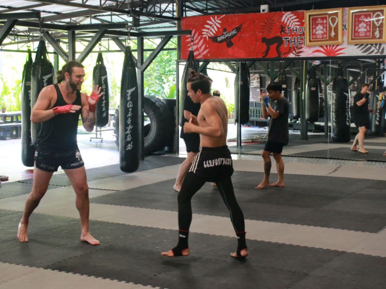 American guest play fights with Thai trainer