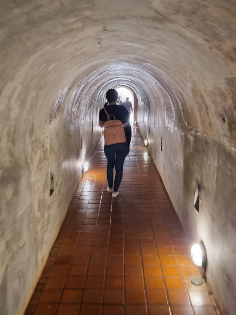 Woman walks through the tunnels at Wat Umong temple