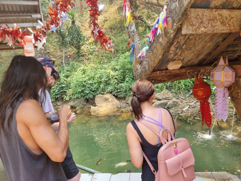 Feeding the koi fish at Chang Dao caves
