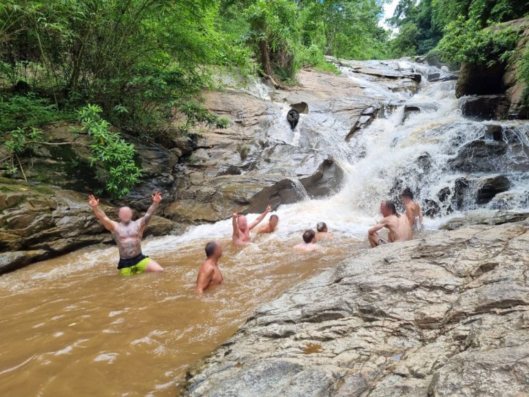Rehab guests have fun in natural waterfall during rainy season
