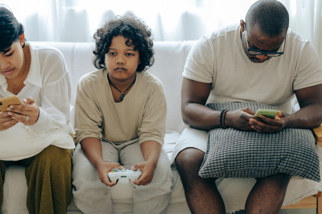 Family distracted by smartphones and computer games