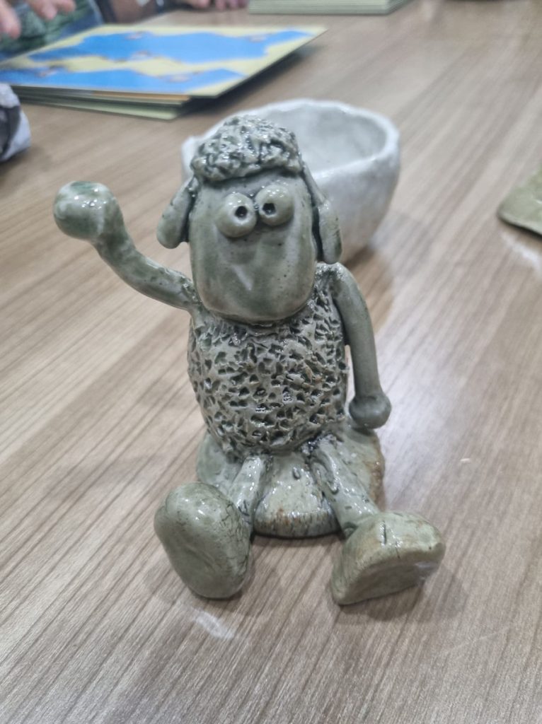 Clients with their clay models after a pottery session