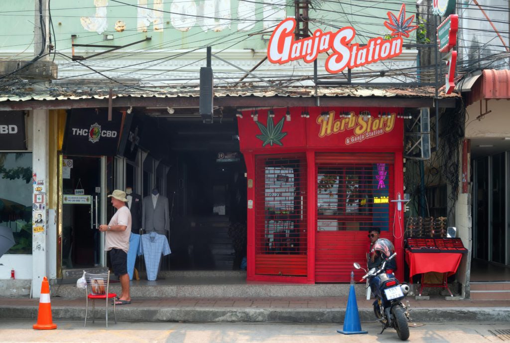 Tourist stands outside cannabis shop in Pattaya, Thailand