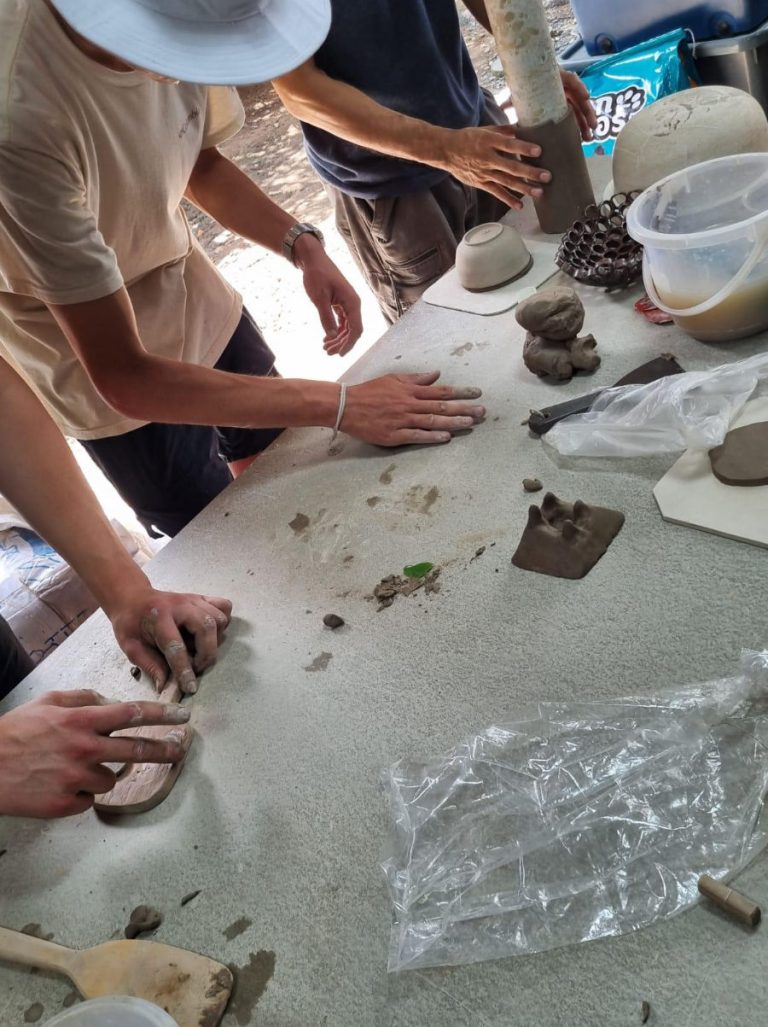 Messy hands shaping and molding clay