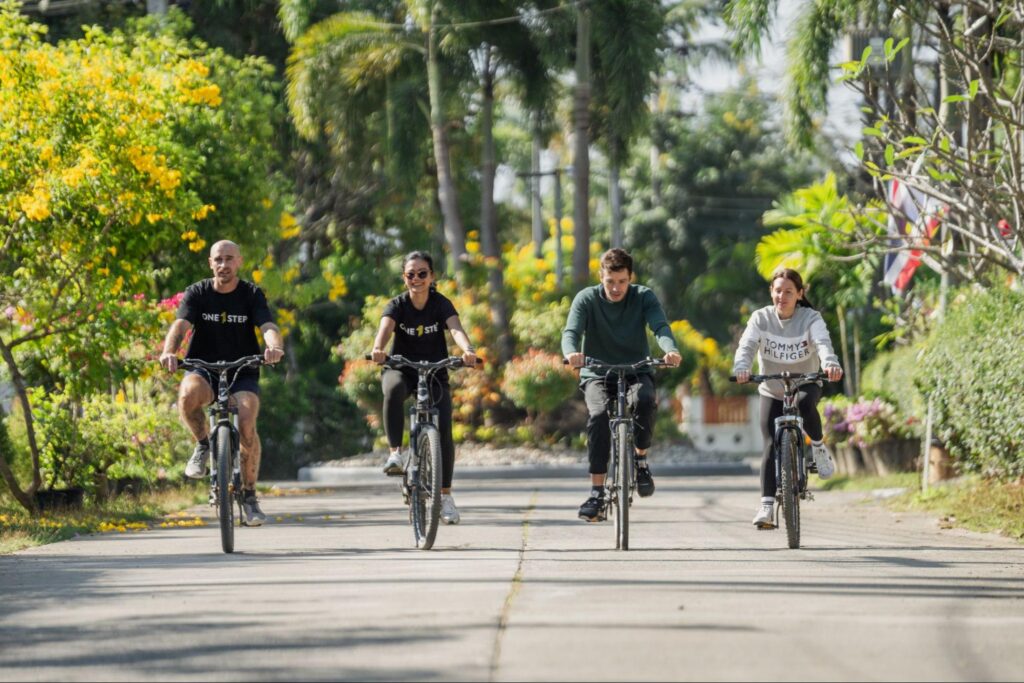 A group of four people cycling around the One Step Rehab facility as part of their fitness and group activity with peers.