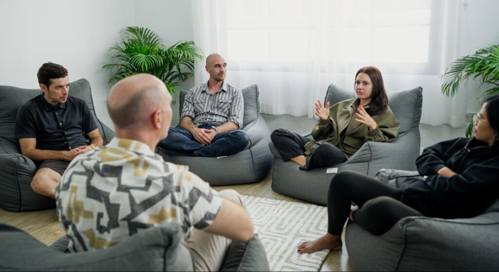 A group of people gathered at One Step Rehab for a group therapy session.