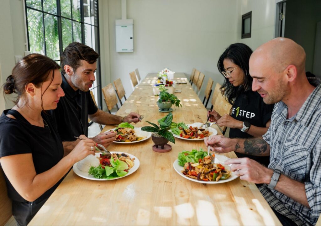 Clients sharing a healthy meal during behavioural addiction recovery at One Step Rehab Thailand