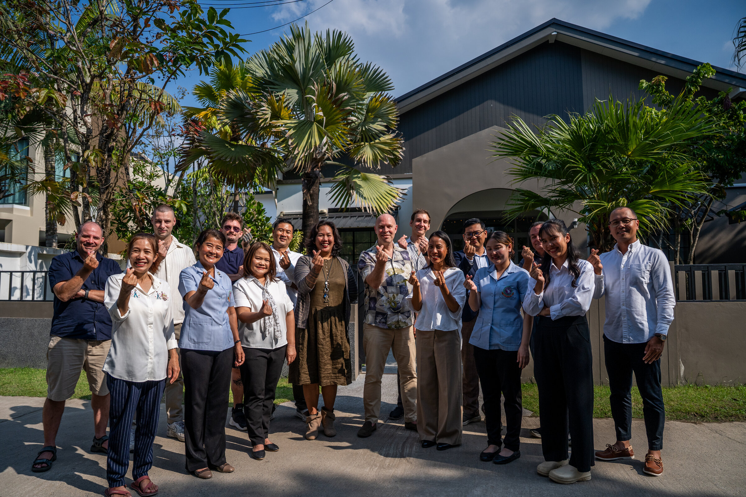 The One Step Rehab clinical team standing in front of One Step Rehab building