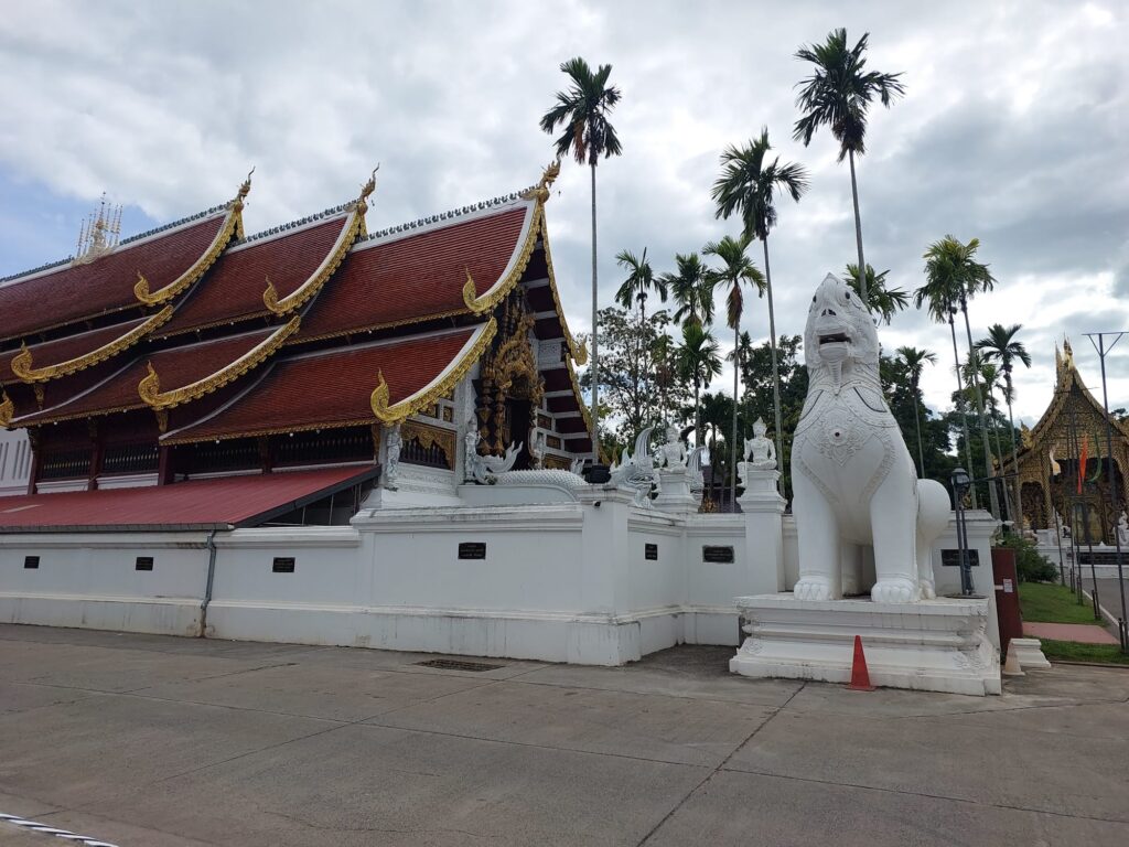 Thai temple with traditional singha guardian statue