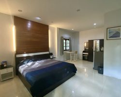 Bedroom with writing desk and hotel amenities