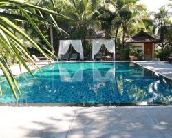 Beautiful swimming pool with shaded sun loungers