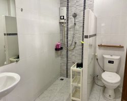 Electric shower in fully tiled bathroom