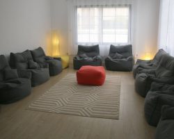 Cozy group counseling room with beanbags and rug